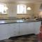 Bespoke handmade tiles with words behind an AGA gas stove for a kitchen in Denmark.