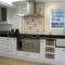 Handmade tiles with hand painted blue Delft style images as a back splash behind a gas stove.