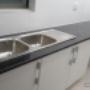 Uploaded by visitor on 2017/07/23 - White melamine cupboard unit with Rustenburg black granite counter top with a drop-in double sink.