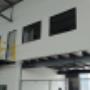 Mezzanine floor with office on top, staircase and handrails.