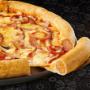 Large Meaty Crammed-Crust® pizza from Debonairs Pizza placed on top of a black plate, on a black background, with shape patterns.