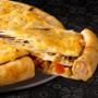 Three-layer pizza with chicken cheese grillers crammed crust on a black table.