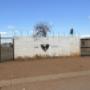 The gate for the Orange Farm Primary School.  The Church of Jesus Christ, located in Orange Farm, on the Orange Farm Primary School grounds, beyond this gate.  Ask attendants to let you through this gate.
