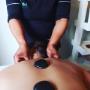 Therapist performing back massage