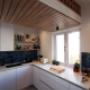 Contemporary kitchen with canopy and bulkhead wine storage