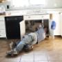 plumber repairing sink Plumbers Network.jpg