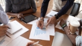 businesspeople-discuss-financial-report
