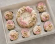 Bento cake with cupcakes for birthday celebration.  Frost